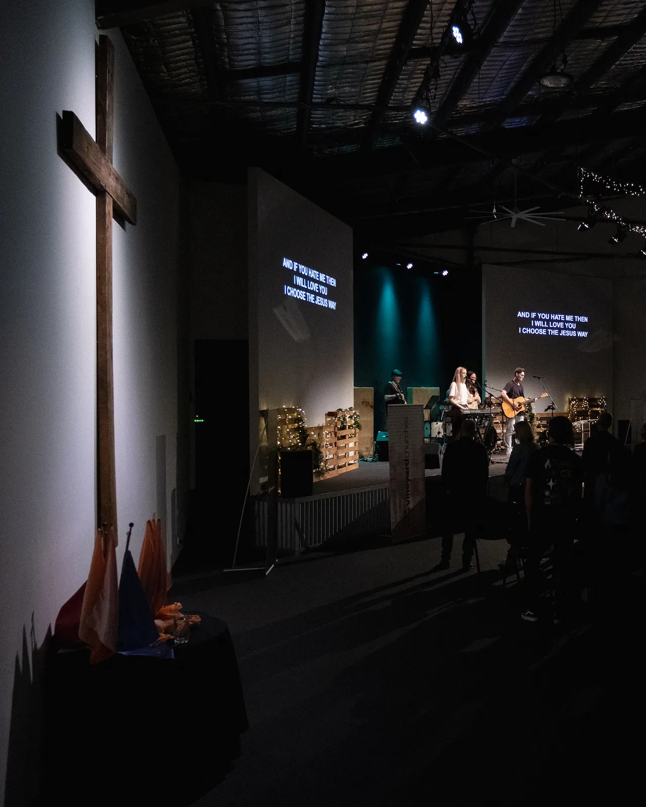 A wooden cross hangs on the sanctuary wall